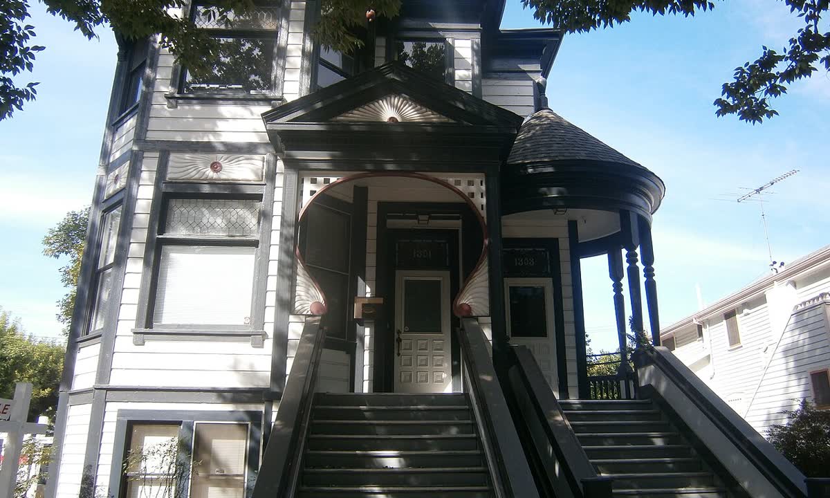 Victorian house with tall front stairs and ornate trim in downtown Sacramento